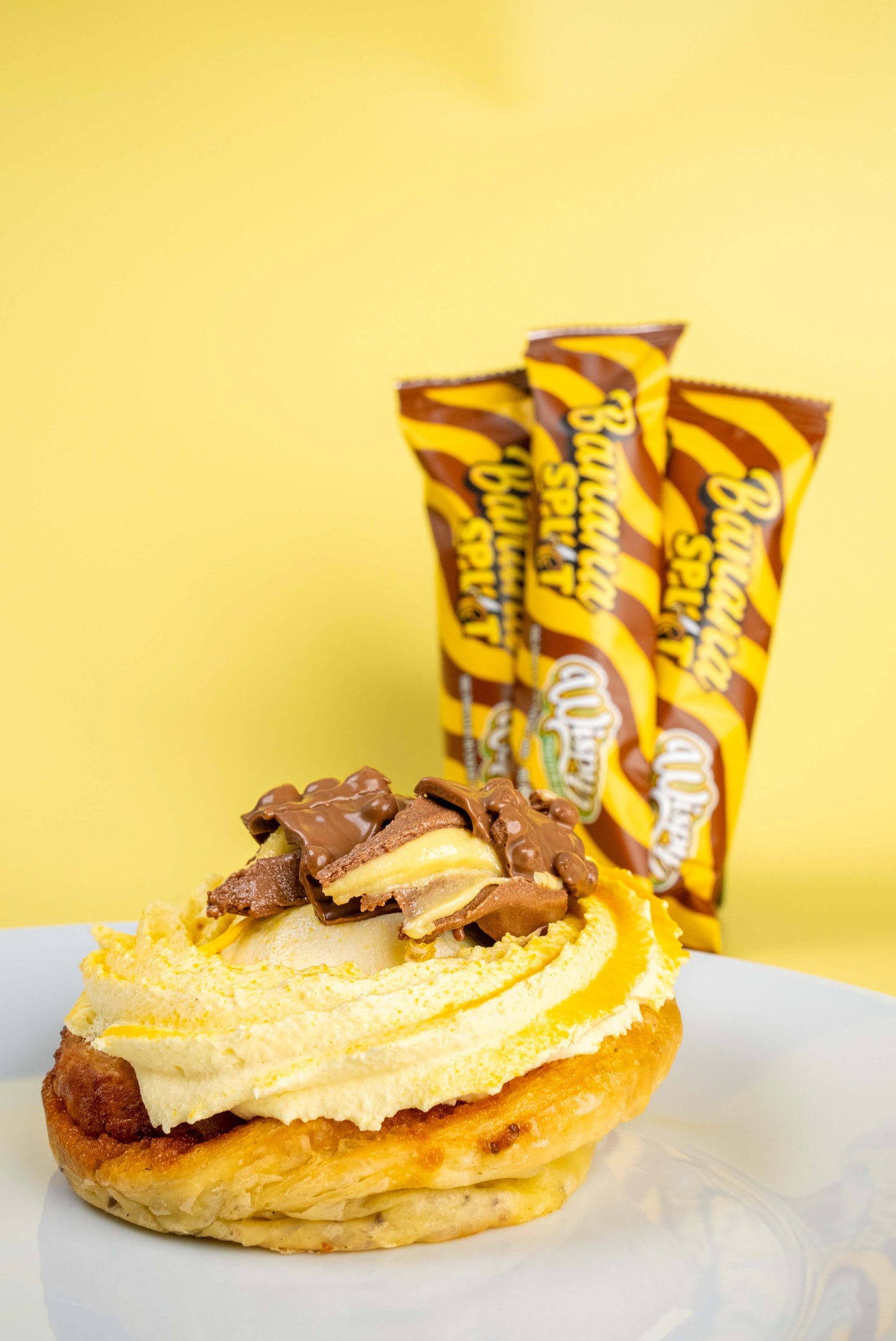 Wispy eiwitreep in de smaak banana split bovenop een pannenkoek met slagroom